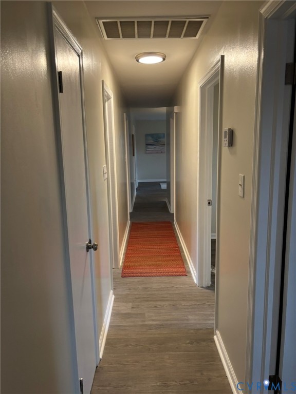 1185 Erica Road Montross, VA 22520 - Photo 29 of 32 Hall with dark wood finished floors and baseboards