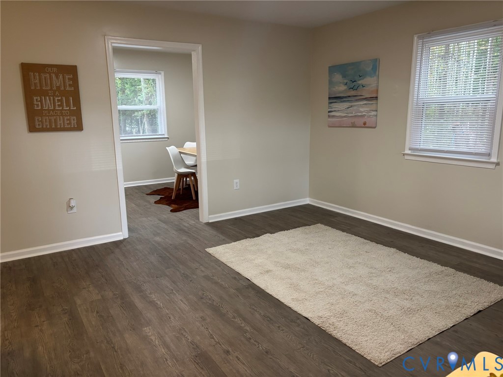 1185 Erica Road Montross, VA 22520 - Photo 6 of 32 Empty room with dark wood finished floors and base