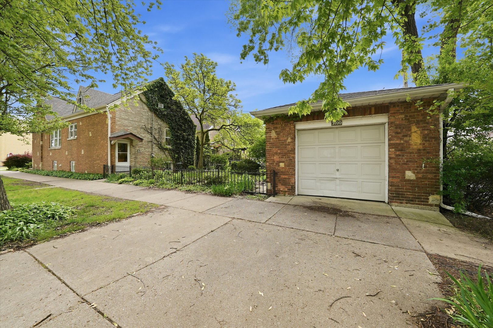 3100 Clinton Avenue Berwyn, IL 60402 - Photo 22 of 25 a front view of a house with a yard and garage