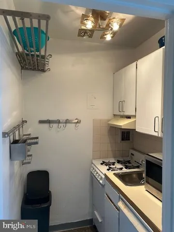 a kitchen with a stove and a refrigerator