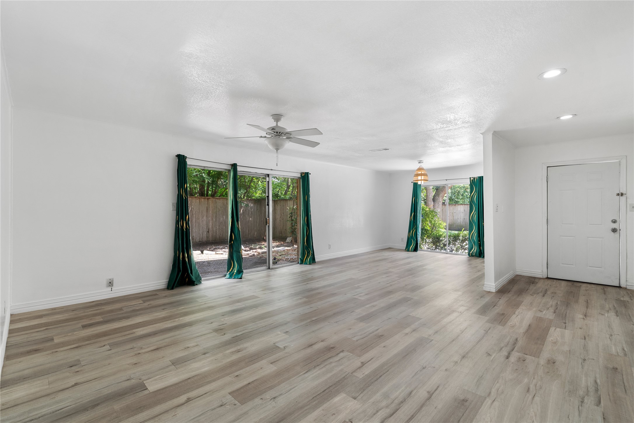 6303 Crab Orchard Road, Unit 3 Houston, TX 77057 - Photo 5 of 30 This perspective showcases the home’s incredible scale. The continuous seamless flooring eliminates transitions, making the space feel massive yet cohesive. Notice the dual access to outdoor spaces, ensuring that every corner of your living area is bathed in natural light and fresh air.