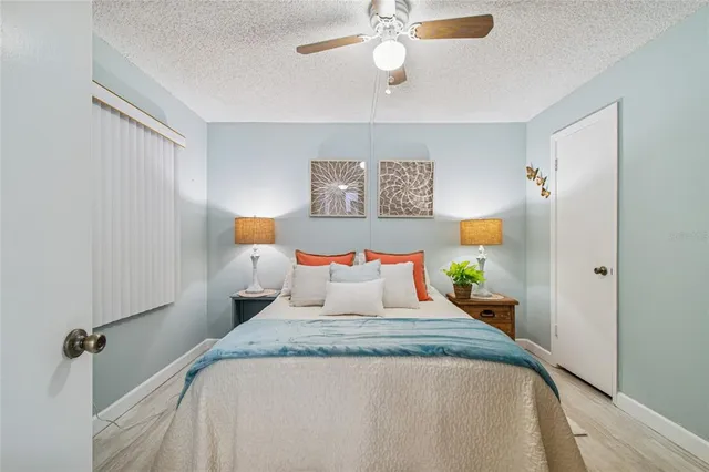 a bedroom with bed and wooden floor