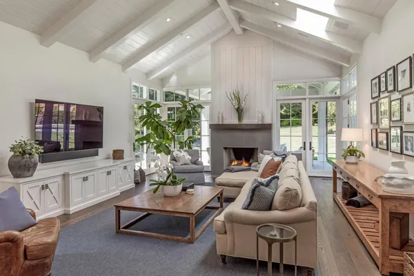 a living room with furniture fireplace and a flat screen tv