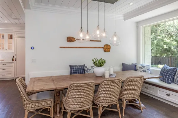 a dining room with furniture a rug and a chandelier