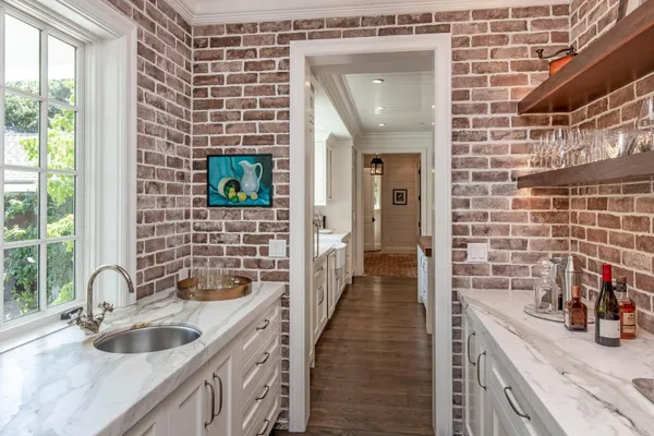 a hallway with a sink and cabinets