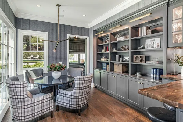 a living room with furniture cabinets and window