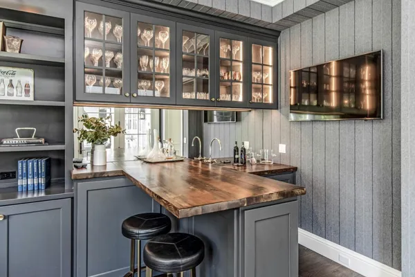 a kitchen with a stove and a wooden floor