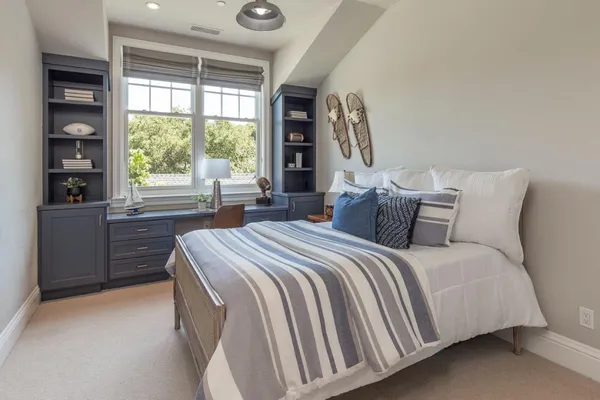 a bedroom with a large bed and a large window