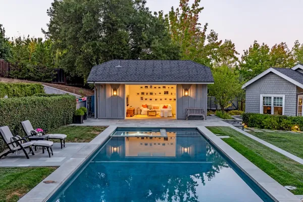 a view of swimming pool with outdoor seating and yard