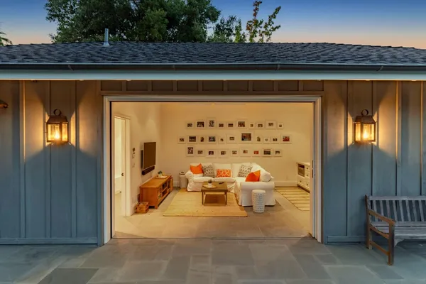 a view of living room filled with furniture and chandelier