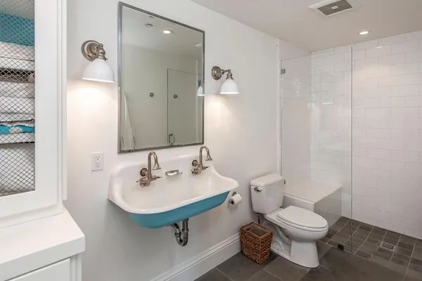 a bathroom with a sink toilet and shower