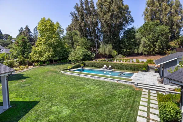 a view of house with backyard outdoor seating and green space