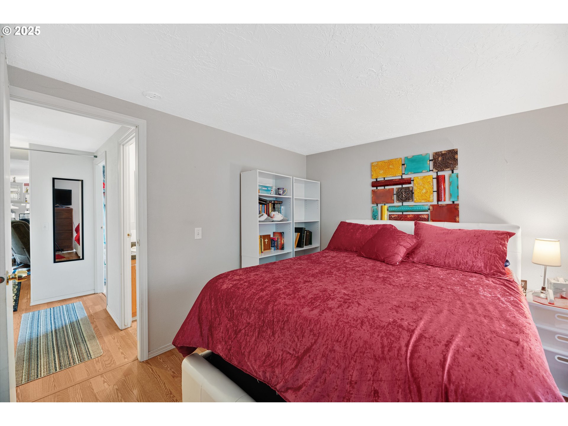 17655 Bluff Road, Unit 42 Sandy, OR 97055 - Photo 15 of 23 a bedroom with a bed and painting on the wall