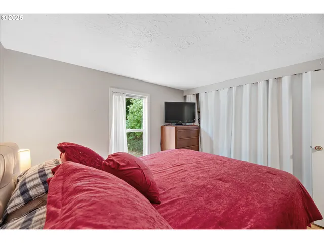 a bedroom with furniture and a book shelf