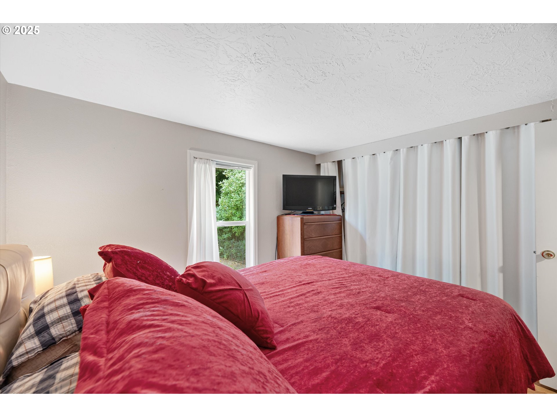 17655 Bluff Road, Unit 42 Sandy, OR 97055 - Photo 16 of 23 a bed sitting in a bedroom next to a window