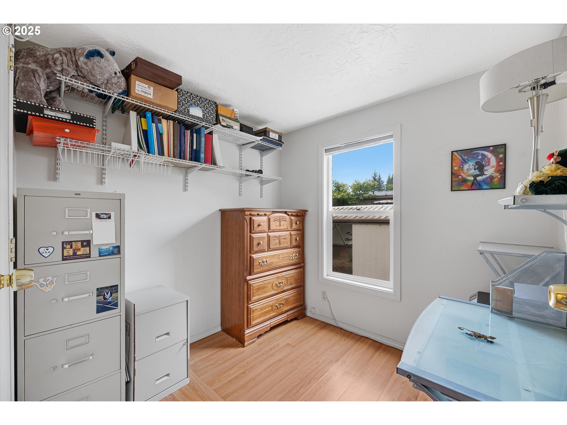 17655 Bluff Road, Unit 42 Sandy, OR 97055 - Photo 17 of 23 a bedroom with furniture and a book shelf