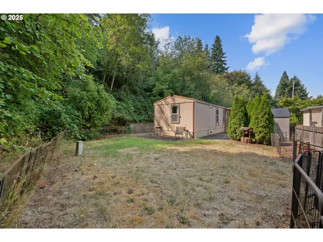 a backyard of a house with table and chairs