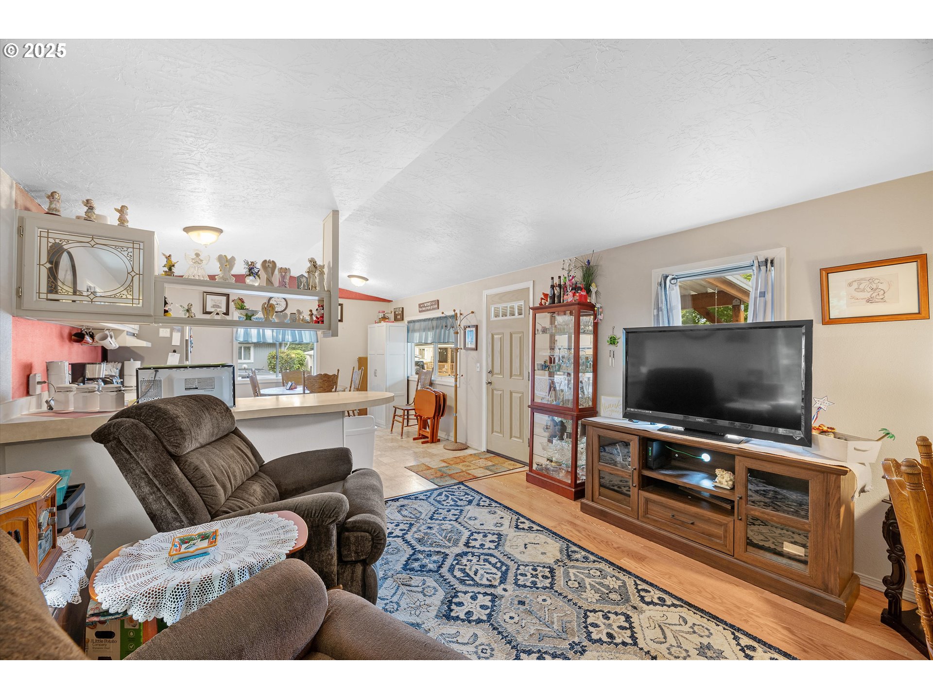 17655 Bluff Road, Unit 42 Sandy, OR 97055 - Photo 3 of 23 a living room with furniture and a flat screen tv