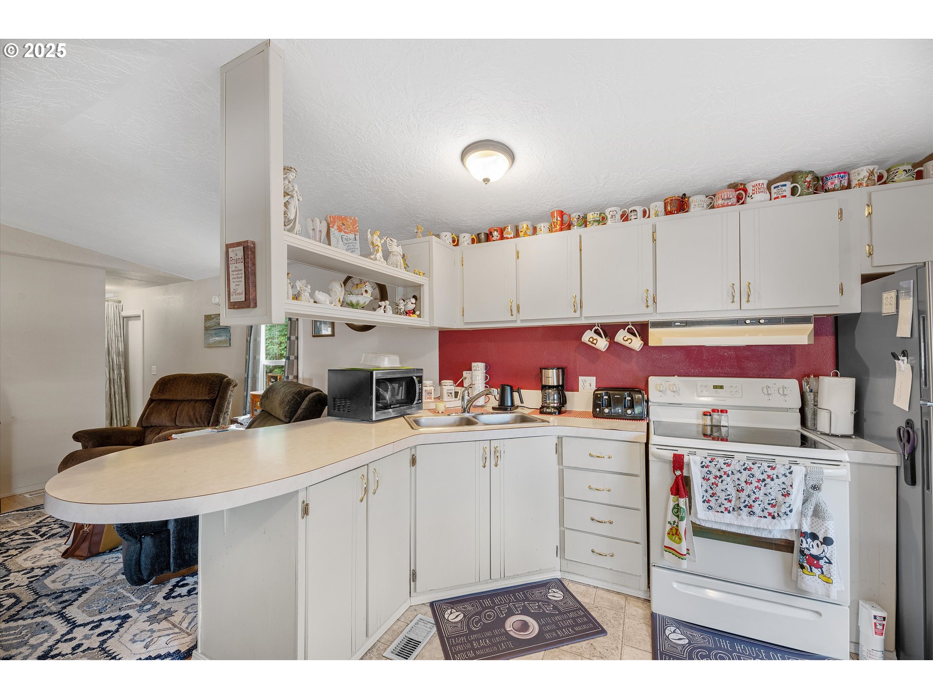 17655 Bluff Road, Unit 42 Sandy, OR 97055 - Photo 8 of 23 a kitchen with kitchen island a sink stove and white cabinets