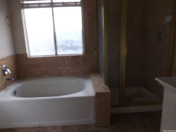 a white bath tub sitting in a bathroom next to a window