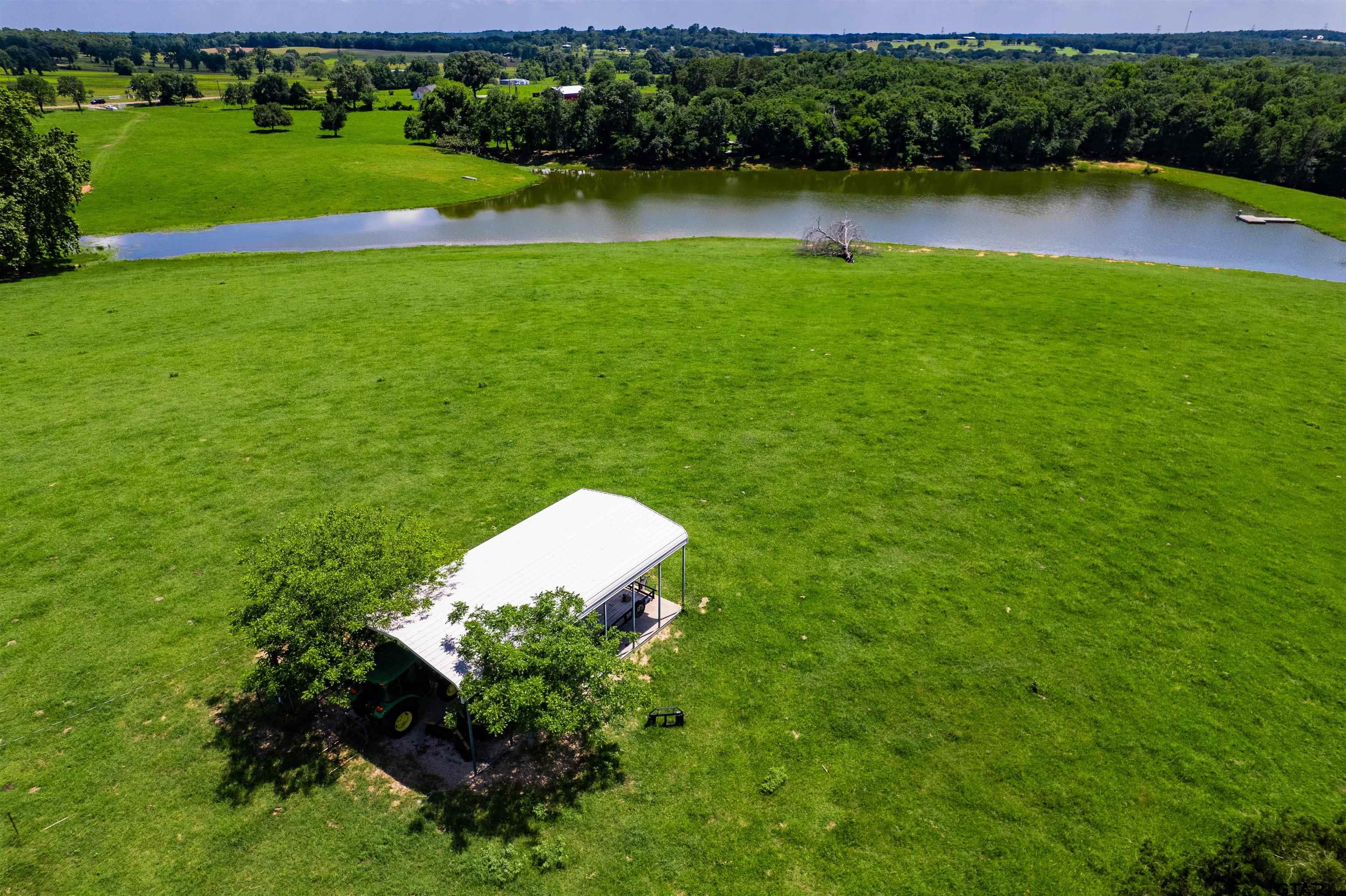 8970 Fm 59 Athens, TX 75751 - Photo 7 of 14 a view of a lake with a houses yard and green space