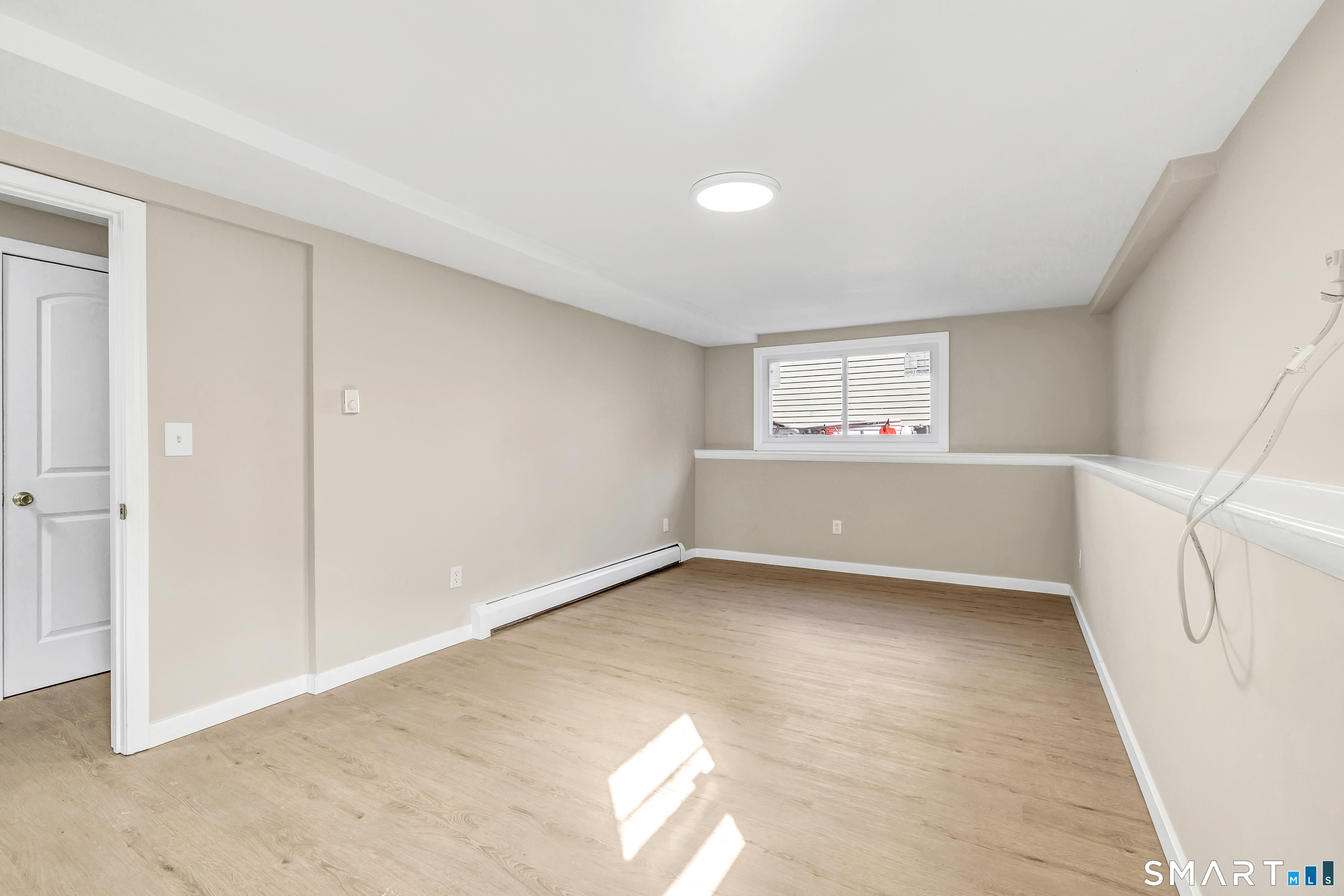 77 Meadow Lark Road Naugatuck, CT 06770 - Photo 24 of 40 Lower level - Finished bedroom, code compliant egress window, vinyl floor, custom built closet with doors, wall unit for cooling