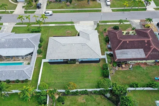 an aerial view of a house with a yard and lake view