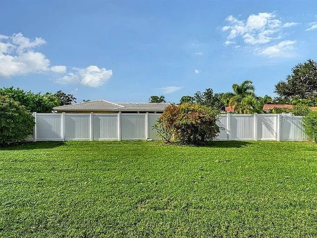 a house with green field in front of it