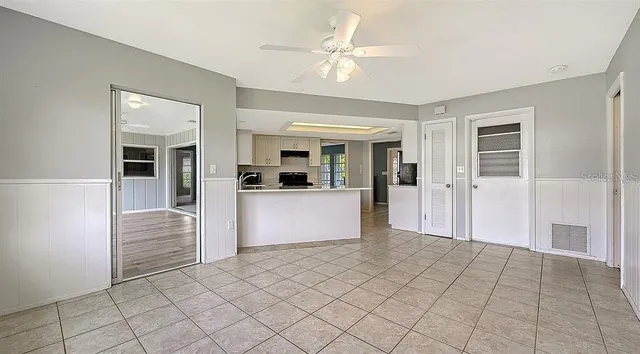 a view of kitchen with furniture and a refrigerator