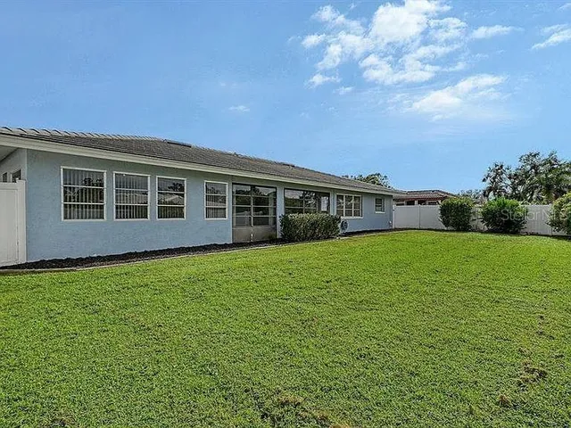 a view of a house with backyard and porch