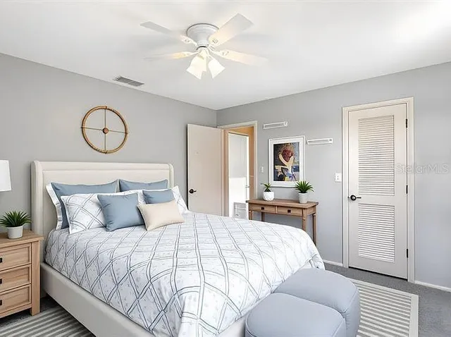 a bedroom with a large bed and window