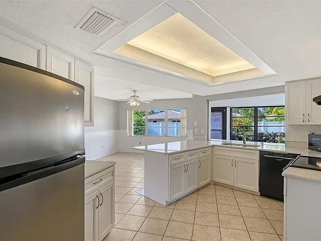 a kitchen with granite countertop cabinets a sink and appliances