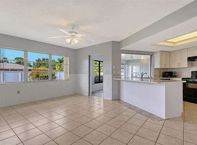 a view of a kitchen with wooden floor and windows