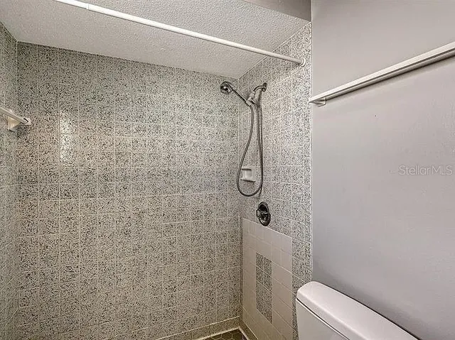 a bathroom with a shower toilet and sink