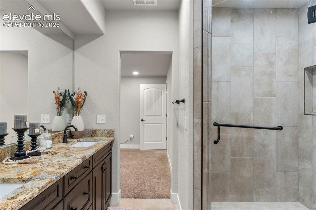2480 North Log Road Calhan, CO 80808 - Photo 32 of 50 Tile shower with bench and glass door
