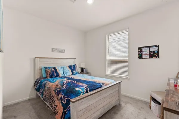 a bed sitting in a bedroom next to a window