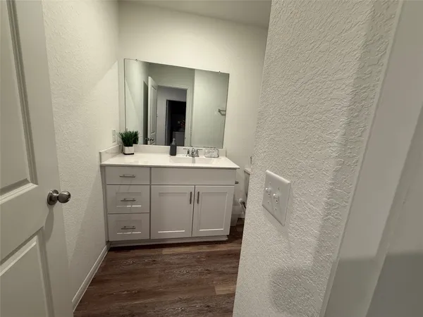 a bathroom with a sink a toilet and shower curtain