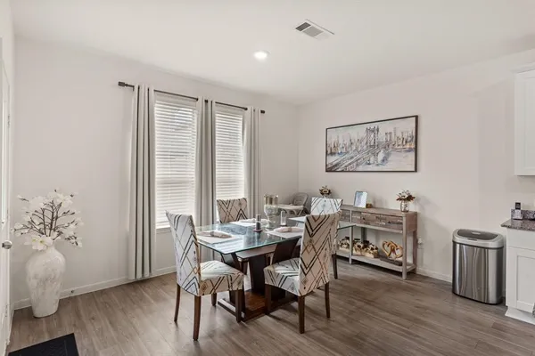 a view of a dining room with furniture window and wooden floor