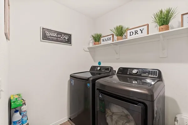 a view of washer and dryer with kitchen countertops