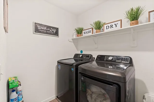 a view of washer and dryer with kitchen countertops