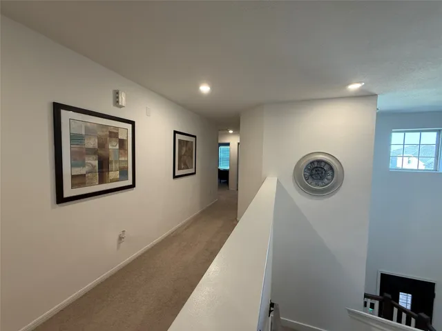 a view of a hallway with paintings on the wall