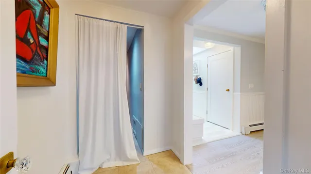 a view of a hallway with paintings on the wall