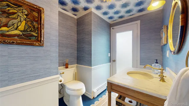 a bathroom with a sink a toilet and a mirror