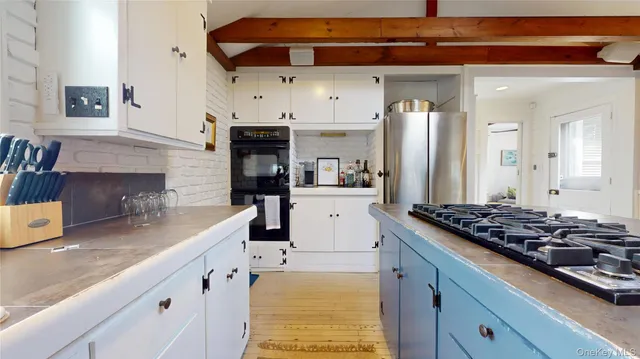 a kitchen with stainless steel appliances kitchen island granite countertop a sink and cabinets