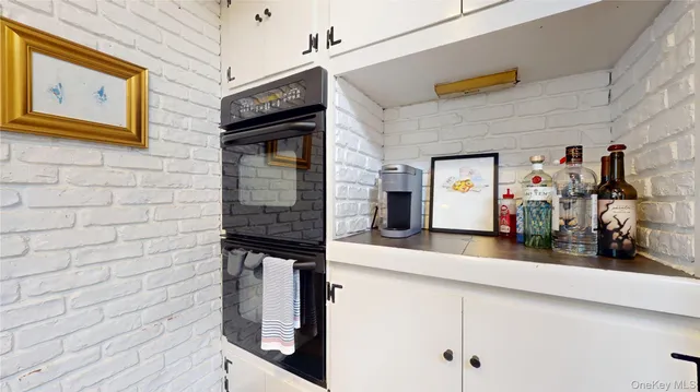 a hallway with front door and wooden floor