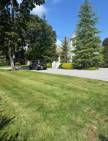 a view of a big yard with large trees
