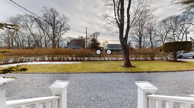 a view of a swimming pool with a yard and large trees