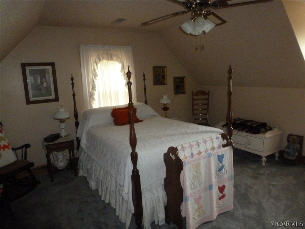 8725 Sandy Ridge Road Hopewell, VA 23860 - Photo 14 of 19 a bedroom with a bed and a chandelier