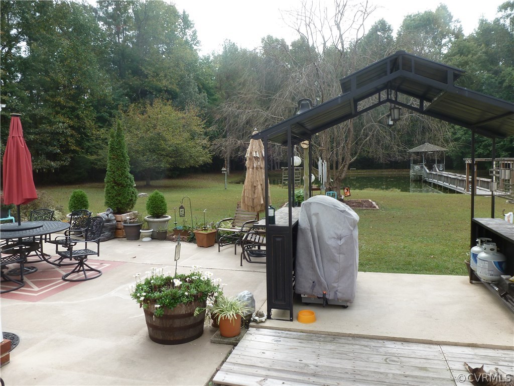 8725 Sandy Ridge Road Hopewell, VA 23860 - Photo 16 of 19 a view of a backyard with sitting area and furniture