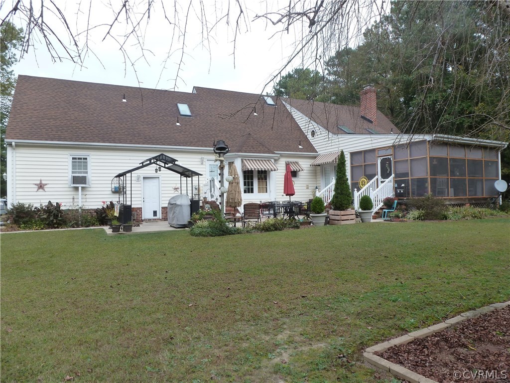 8725 Sandy Ridge Road Hopewell, VA 23860 - Photo 17 of 19 front view of a house with a yard